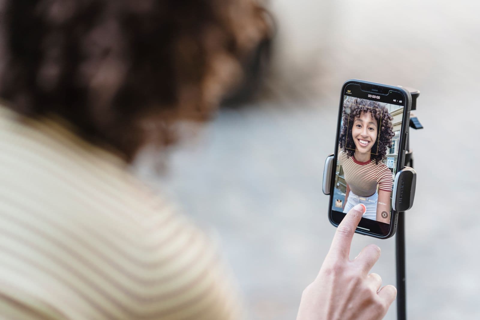 woman recording a video of herself on her phone