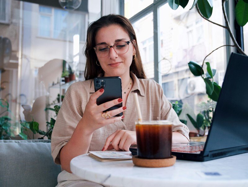 professional woman on cell phone in coffee shop