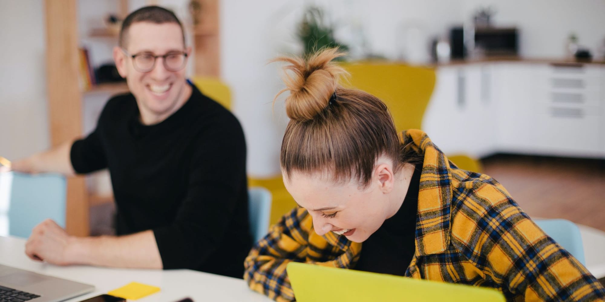 woman and man in the office laughing 