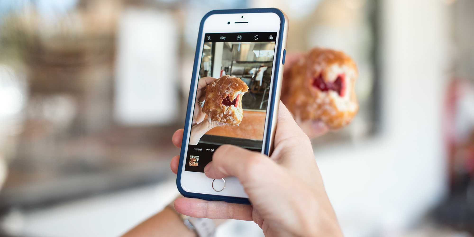 Person taking a picture of a pastry